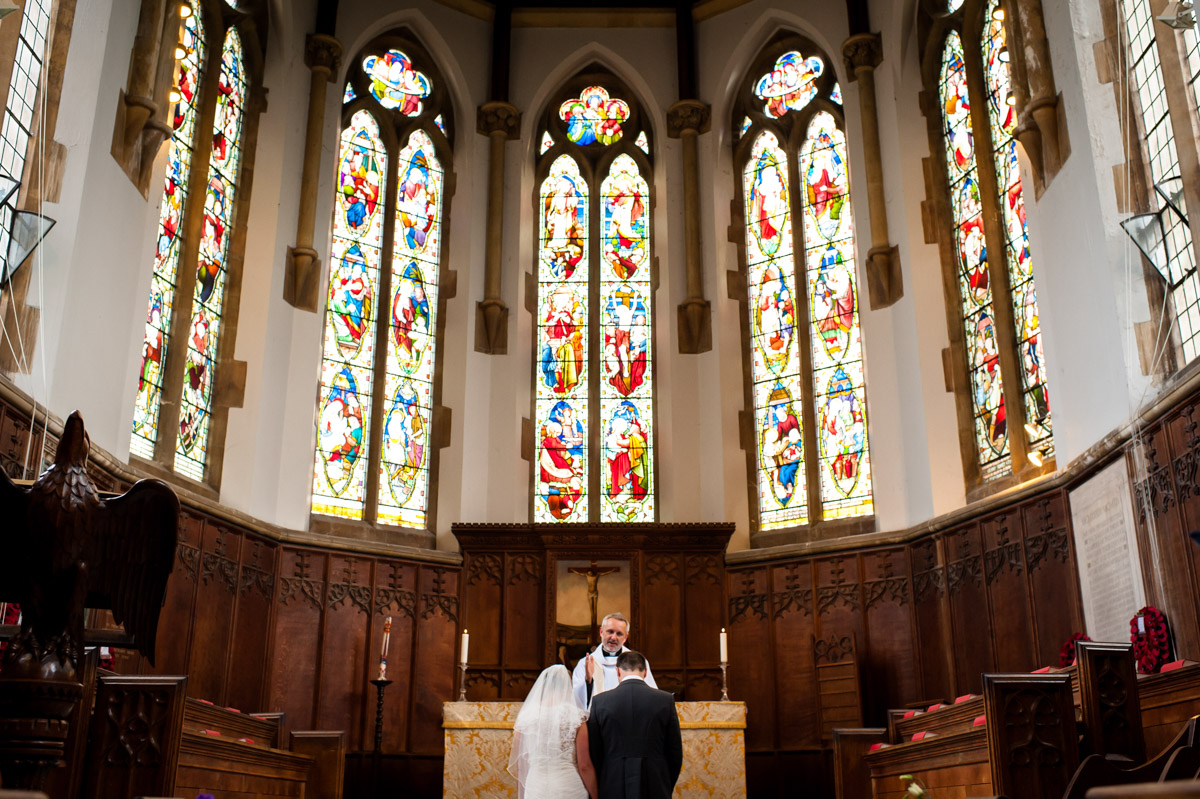 Bride and Groom at the alter in St Edmunds Chapel, Canterbury on their wedding day