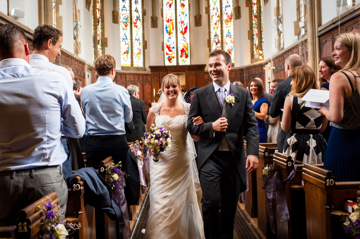 Bride and Groom walk back down the aisle in St Edmunds Chapel after their wedding ceremony