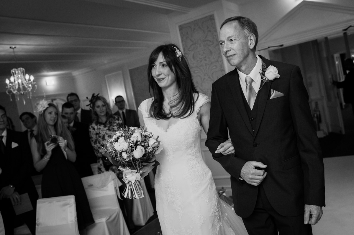 Wedding ceremony in The Imperial Suite at the Hythe Imperial Hotel, father walks daughter down the aisle