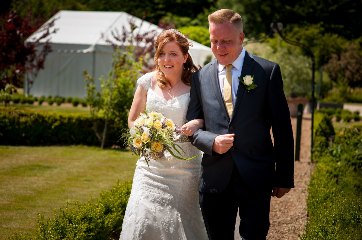 Amy and dad walking down the aisle at The Secret garden in ashford Kent