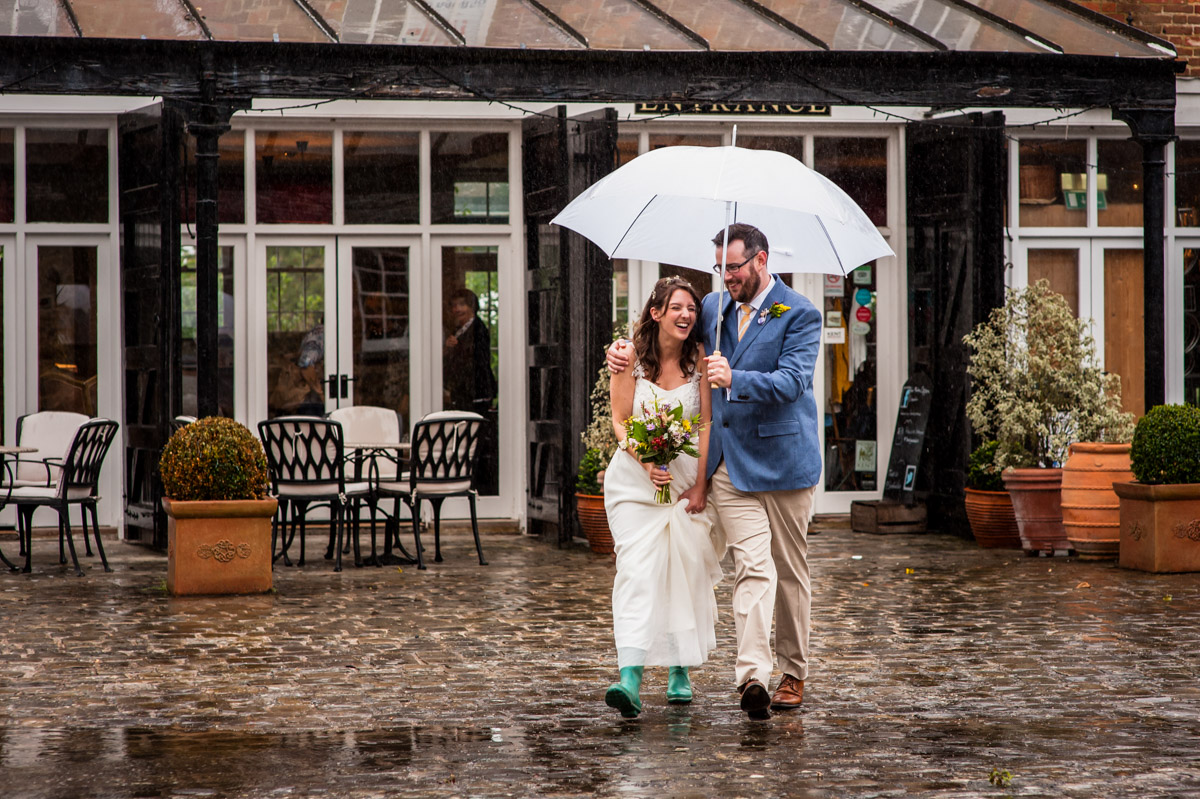 rainy wedding couple photograph in the secret garden courtyard