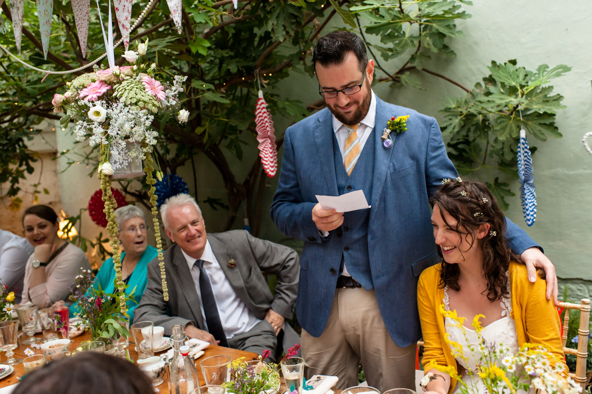 daniel makes his wedding speech in the glass house at the secret garden in kent