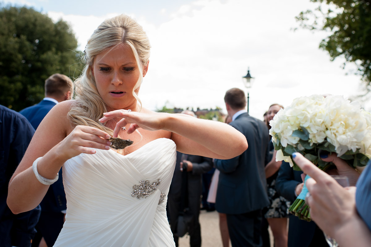 Bride eats oyster at her wedding reception in Whitstable Kent
