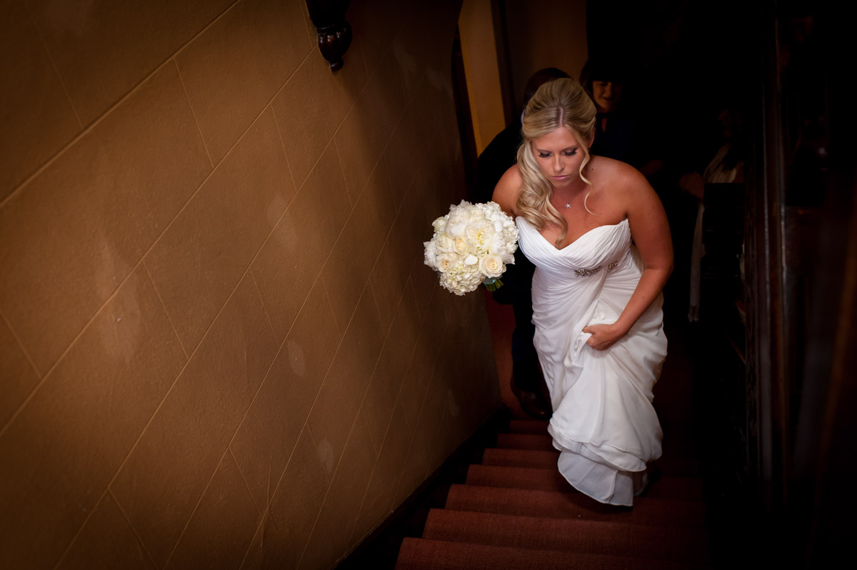 Lauren walks up steps at Whitstable castle before her wedding ceremony