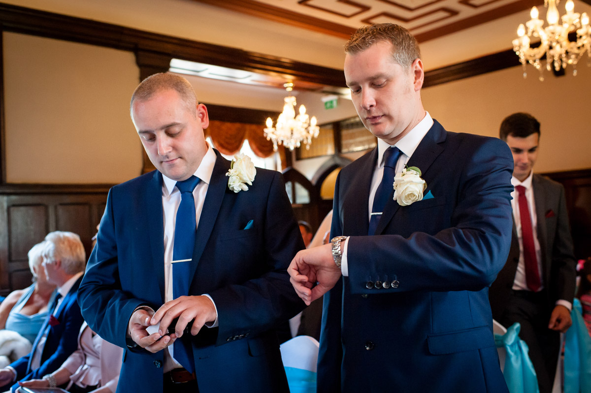Groom photographed checking his watch before the wedding ceremony at Whitstable Castle
