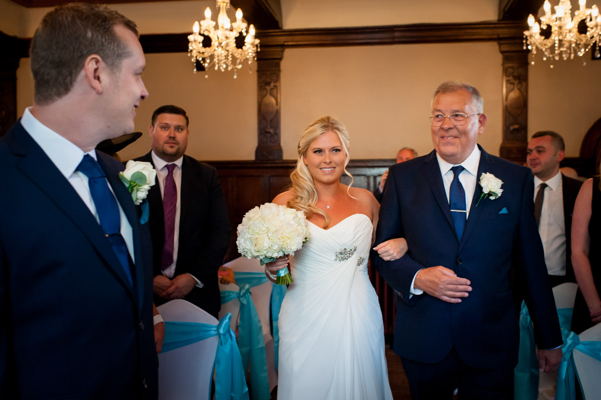 Father escorts Lauren down the aisle during wedding at Whitstable Castle