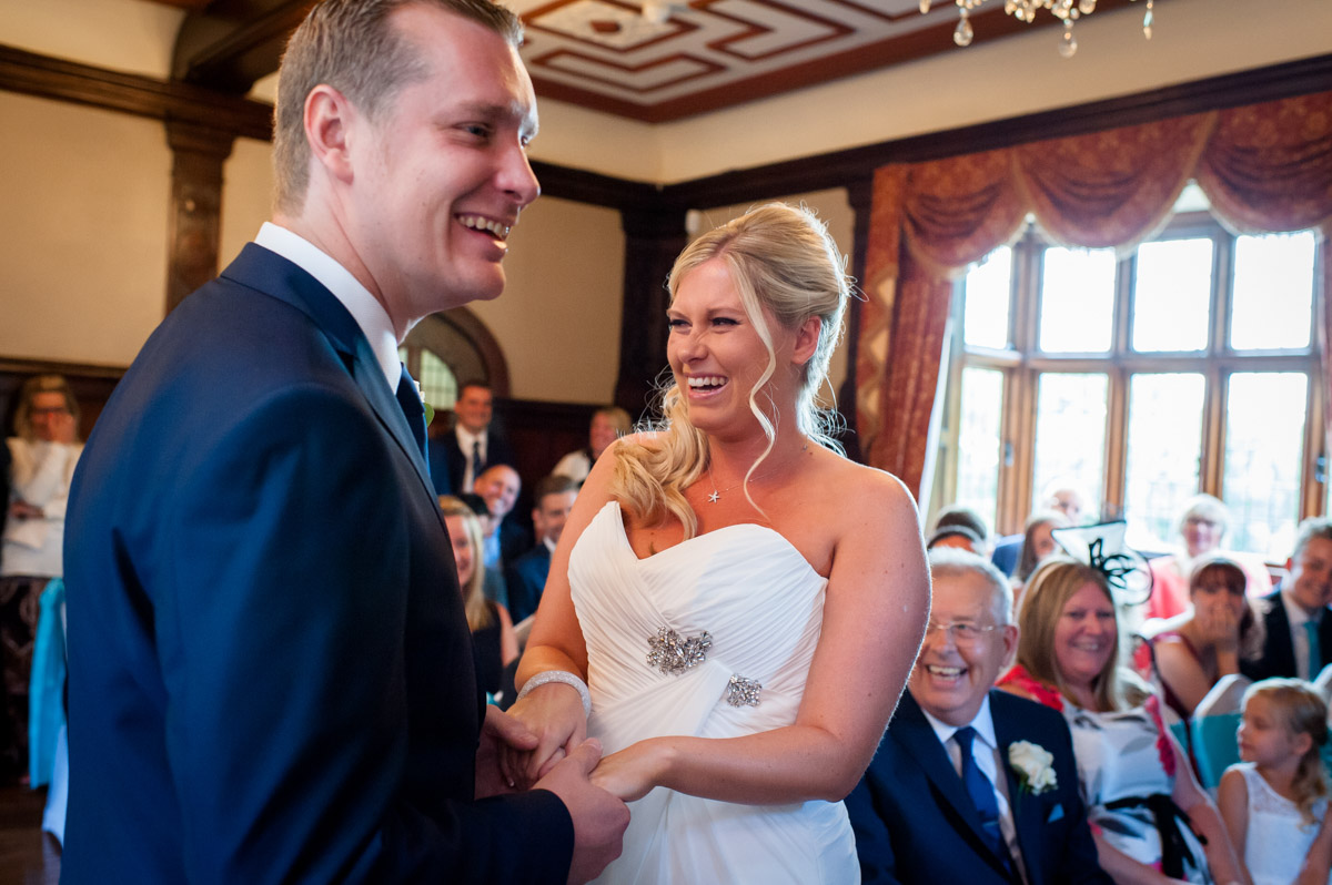 Lauren and Jay laughing during their wedding ceremony at Whitstable castle