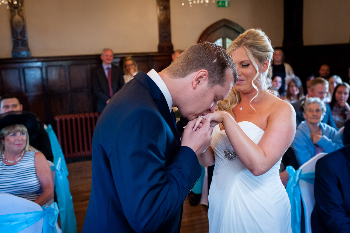 Photograph of Jay kissing Laurens hand after their wedding ceremony at Whitstable Castle