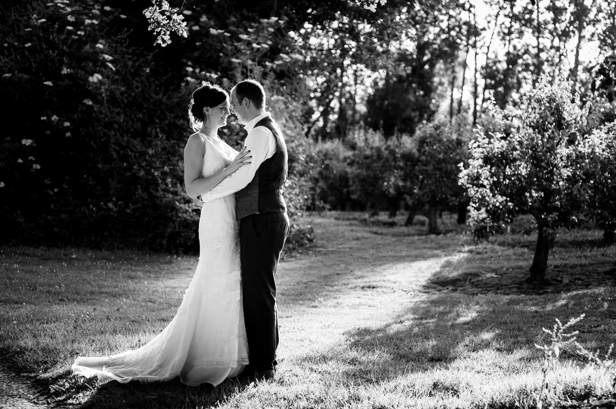 photograph of mark and gaby in the orchards at their wedding reception