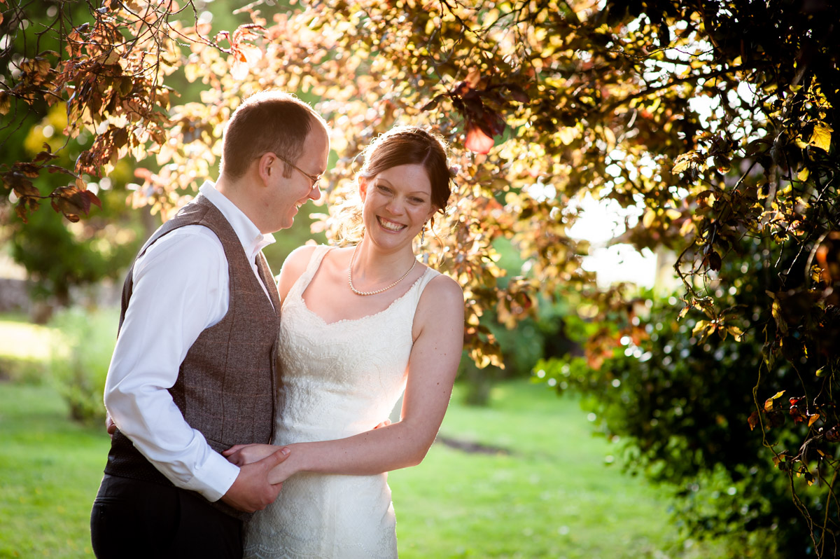 photograph of gaby and mark in the orchard at their wedding reception venue
