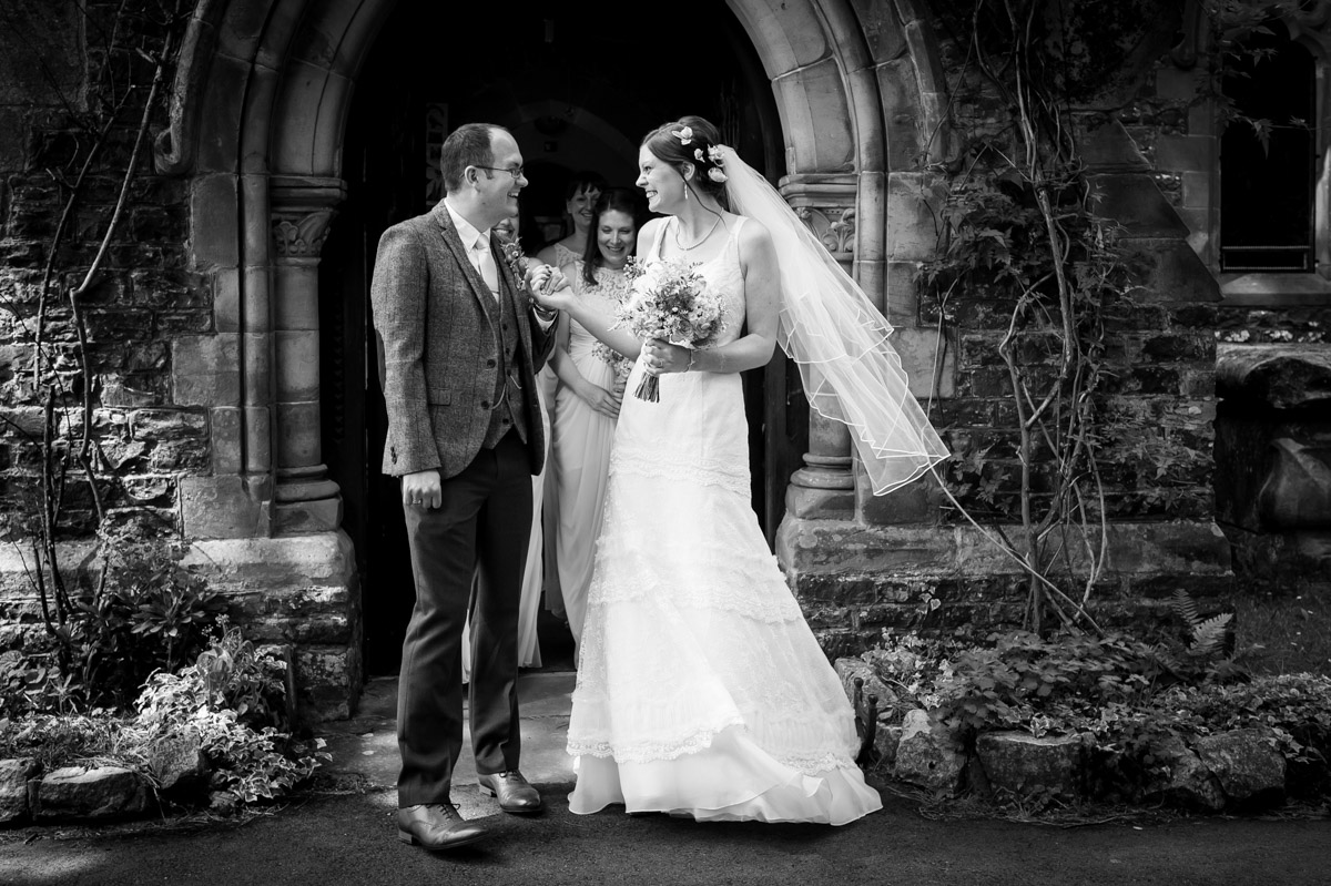 gaby and mark outside the church in the woods after their wedding ceremony