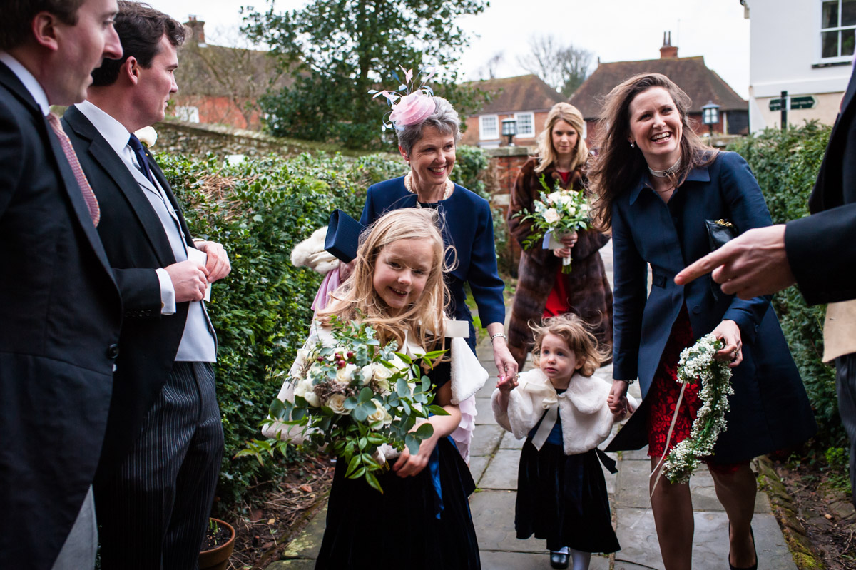 Friends and family arrive at Elham church for Frances and Marcus's Kent winter wedding