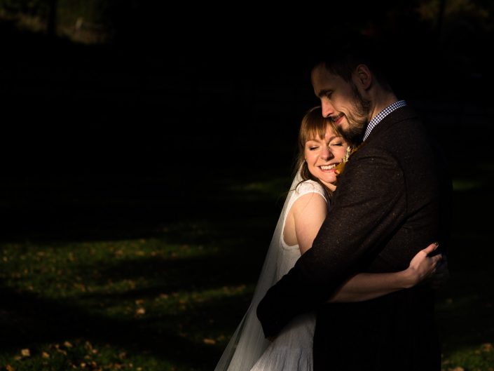 Beautiful sunlit photograph of Laura and Paul during their wedding reception at Chilham Village Hall near Canterbury in Kent
