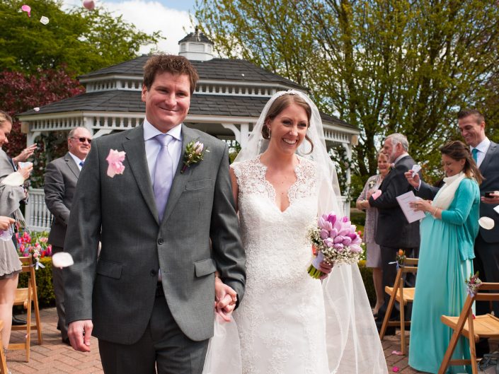 Bronwyn and Warrick walk down the aisle after their outside wedding ceremony at the Old Kent Barn in Kent