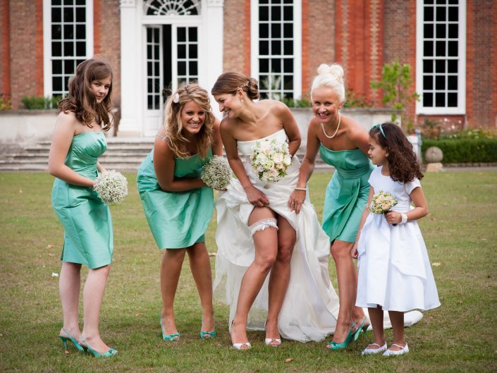 Photograph of bride and her bridesmaids having fun iat Bradbourne House near Maidstone in Kent