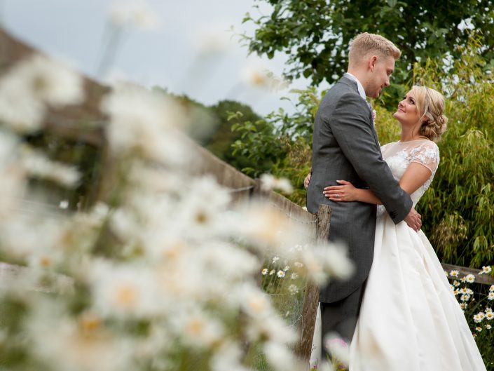 Aimee and Billy are photographed together after their Kent church wedding near Maidstone in Kent