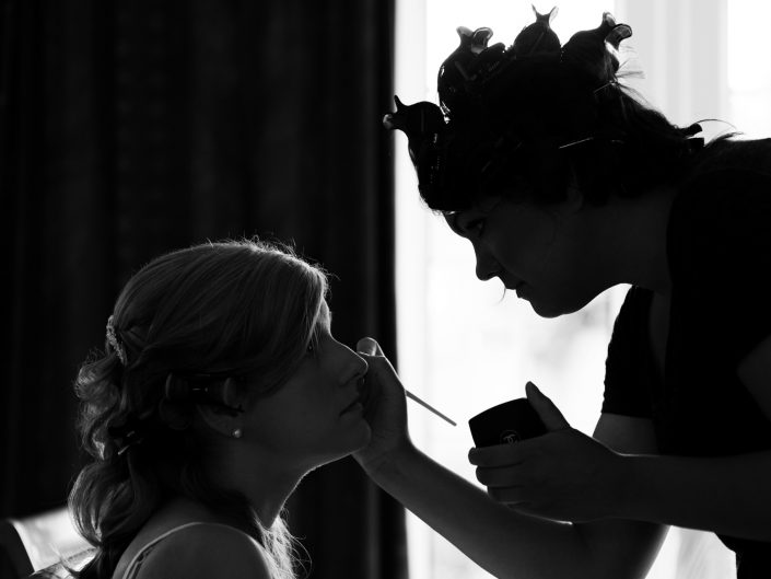 Black and white photoraph of bride having her make up applied before her wedding near Maidstone in Kent