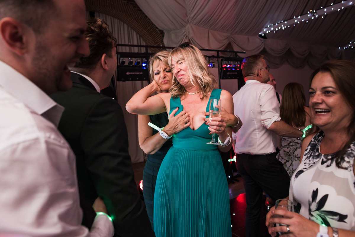 Photograph of wedding guests having fun at David and Simons wedding day at Port Lympne in Kent