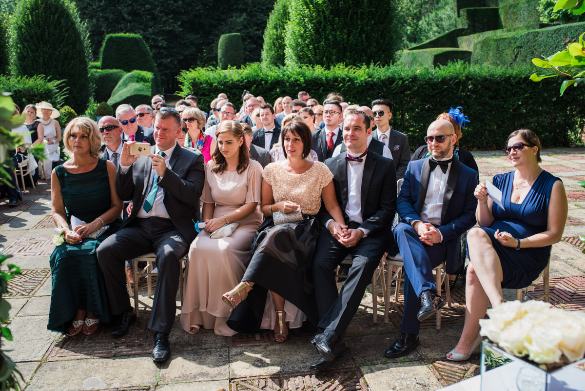 Guests are photographed at David and Simons Kent wedding reception at Port Lympne