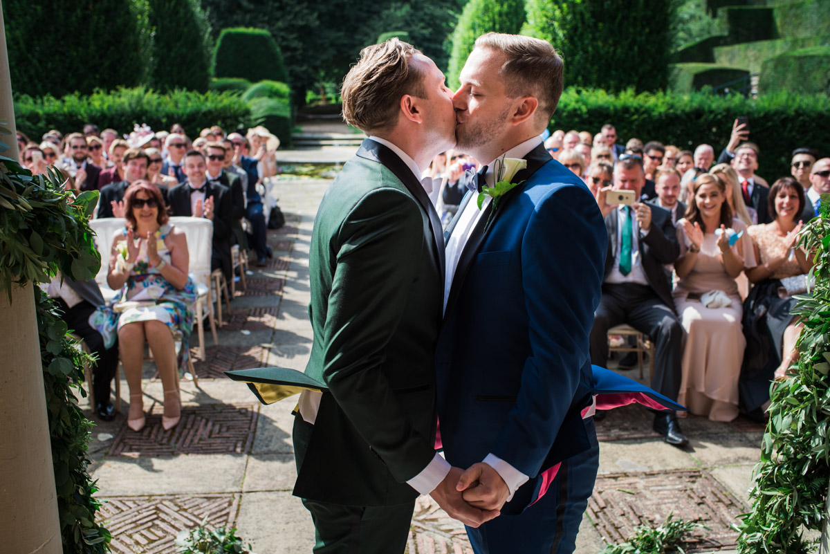 Photograph of first kiss during david and Simons wedding iat port Lympne Mansions in Kent