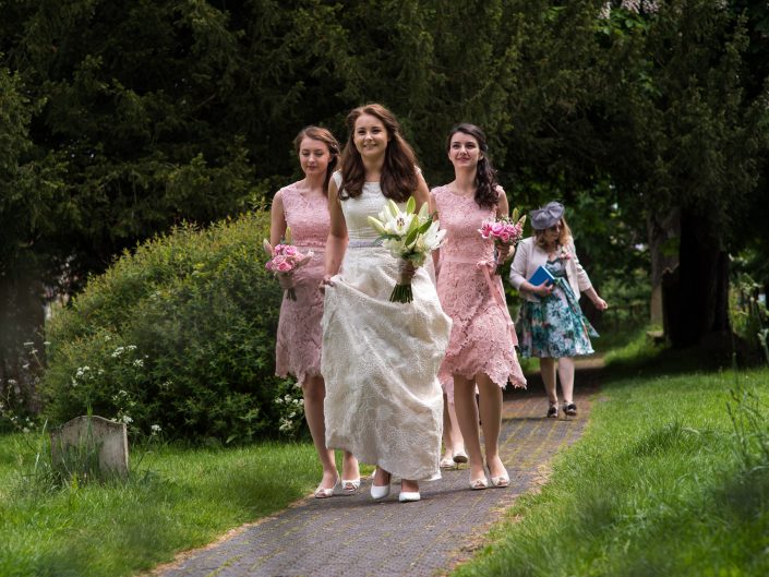 Harriet and her bridesmaids walk to the church on her wedding day in Kent