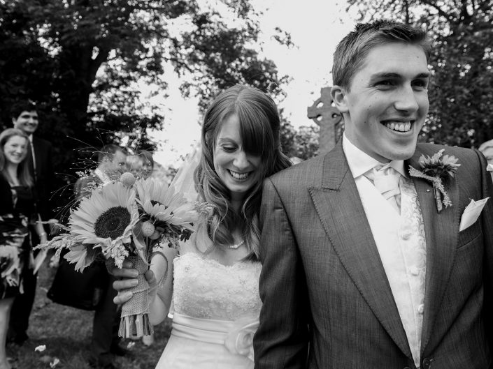 Black and white photograph of Laura and Adam after their Kent church ceremony