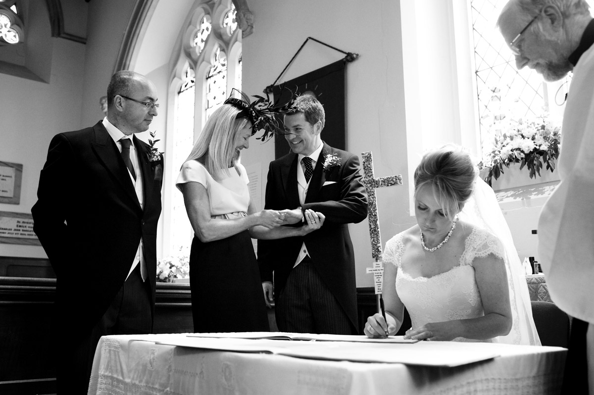 Kate signs the wedding register after their Kent wedding ceremony