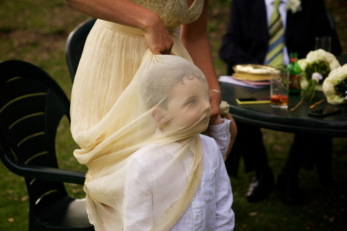 Little boy gets wrapped up in bridesmaid dress at Tim and Andreas Kent wedding