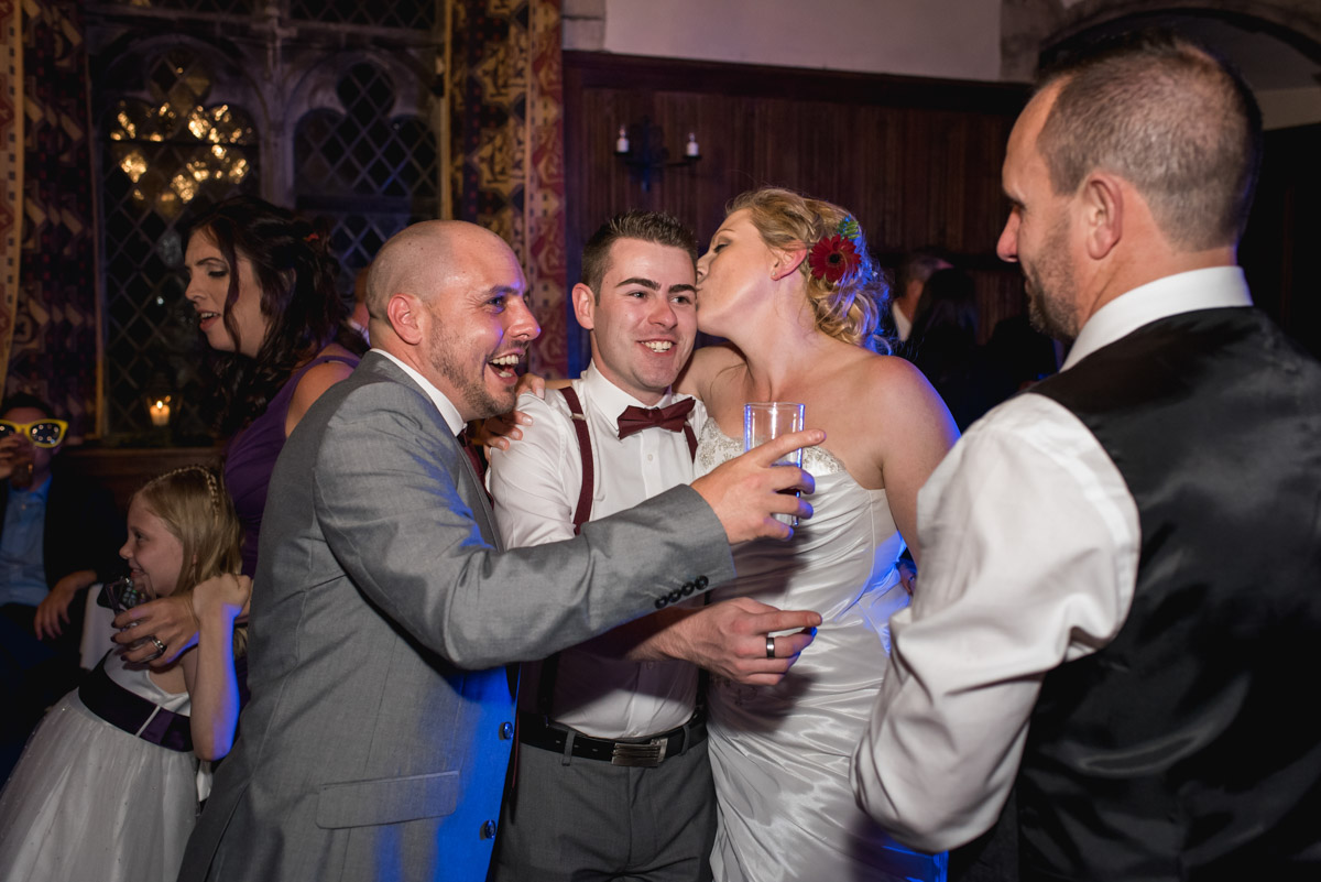 Guest and John and Lianne photographed on the dance floor during their wedding reception at Lympne Castle in kent