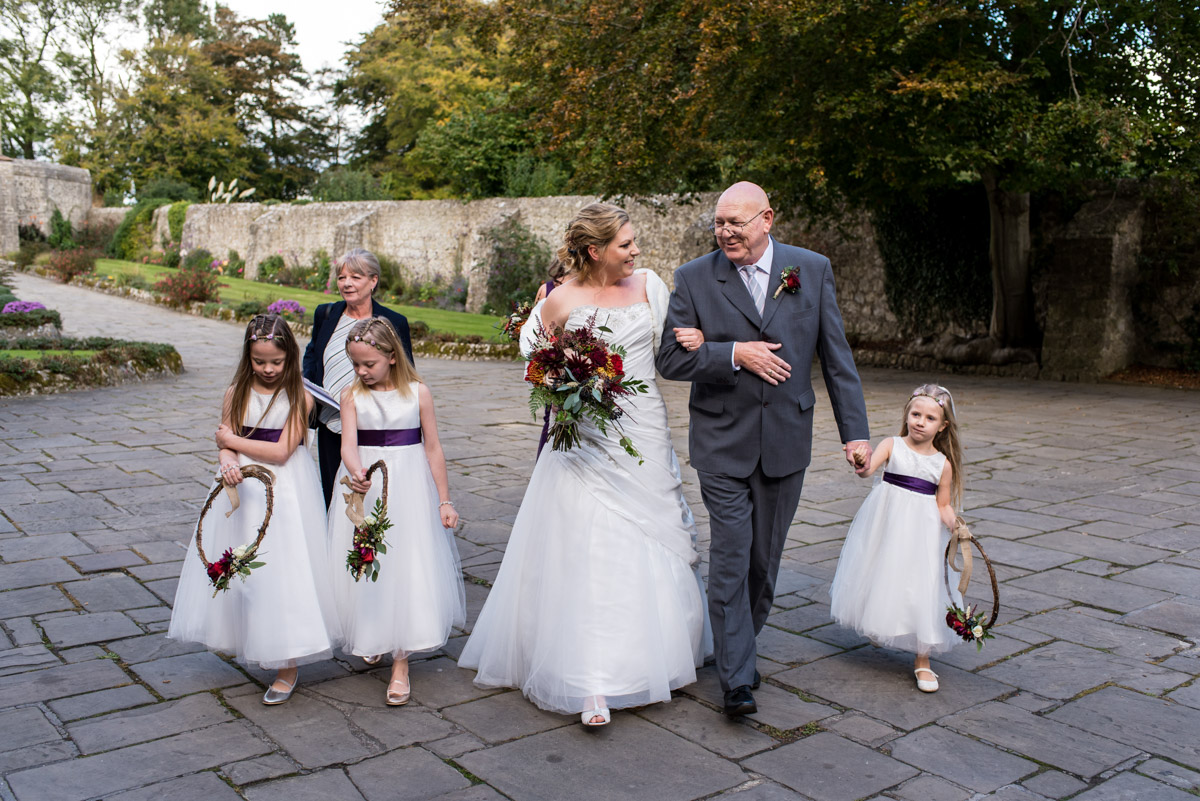 Photograph of Lianne & her father along with mum and flower girls before the ceremony at Lympne Castle In Kent