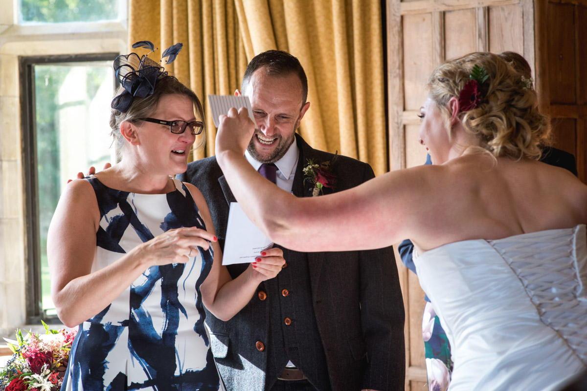 Photograph of Lianne drying her friends tears while she does her wedding reading during the ceremony at Lympne Castle in Kent