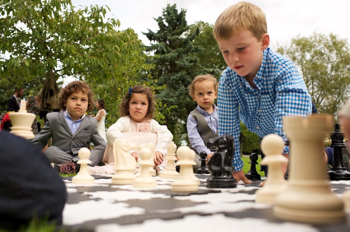 Children play giant chess at Juliuette and Davids wedding day celebration party