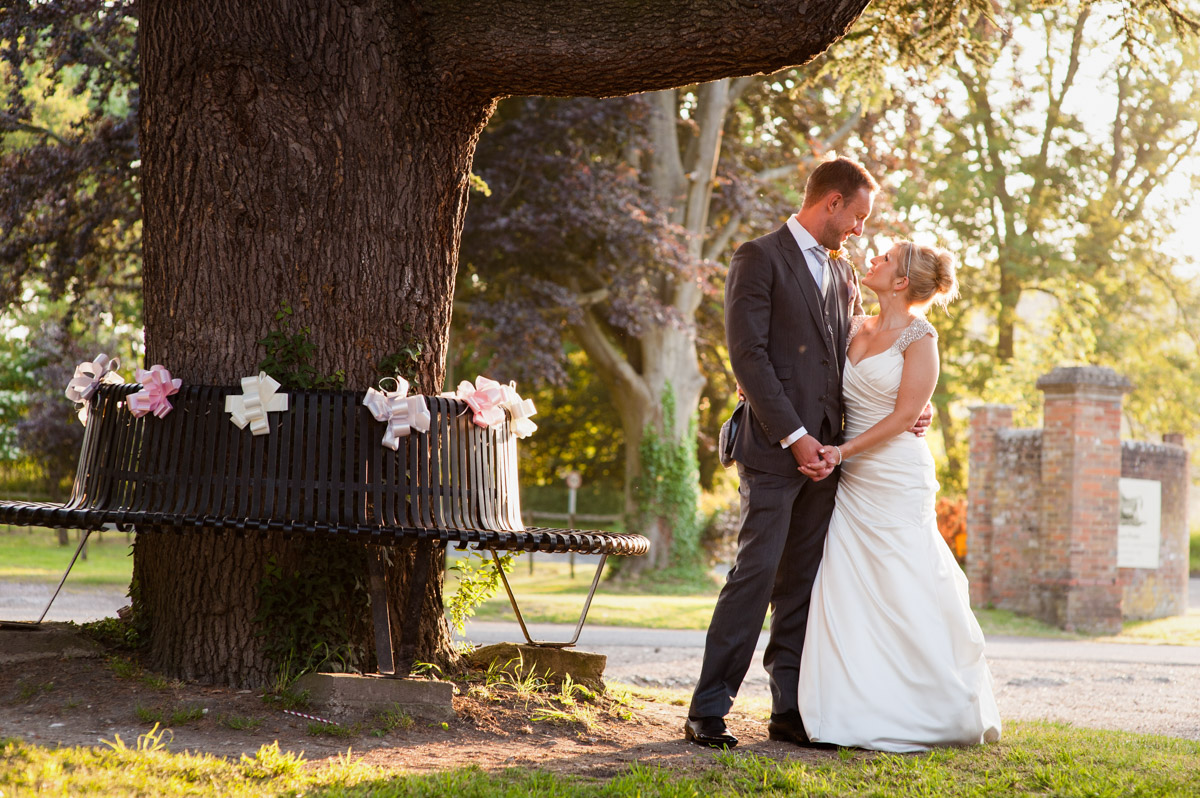 Evening photograph of Emily and Rob outside Chilham Village Hall on their wedding day