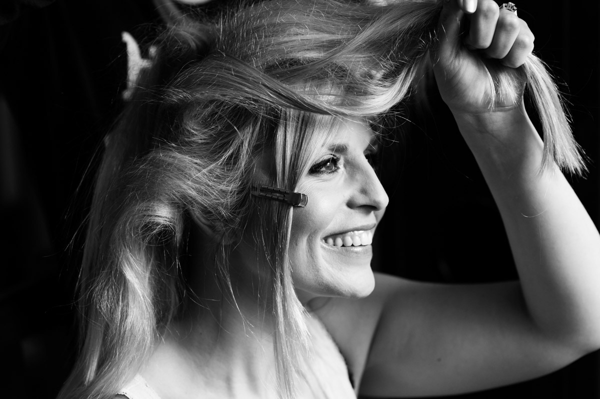 Blacka nd white photograph of Emily having her hair done before her wedding in Kent