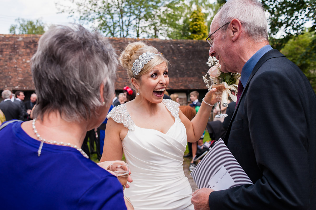 Photograph of Emily greeting wedding guests at her wedding in Kent