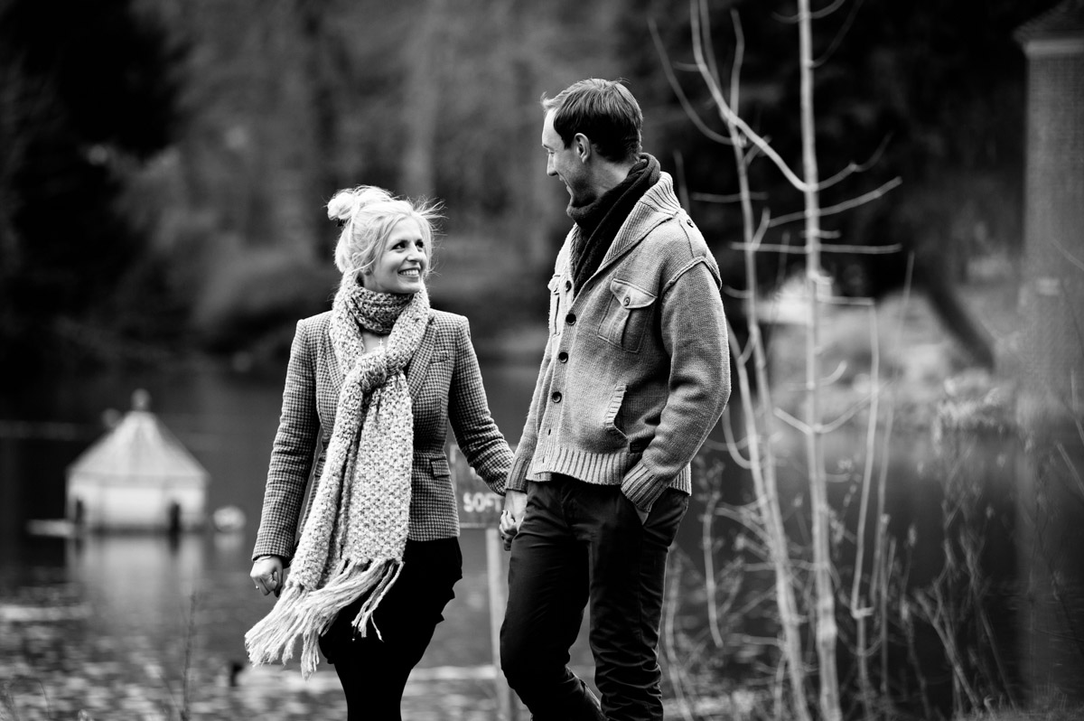 Black and white pre wedding photograph of Emily and Rob walking hand in hand