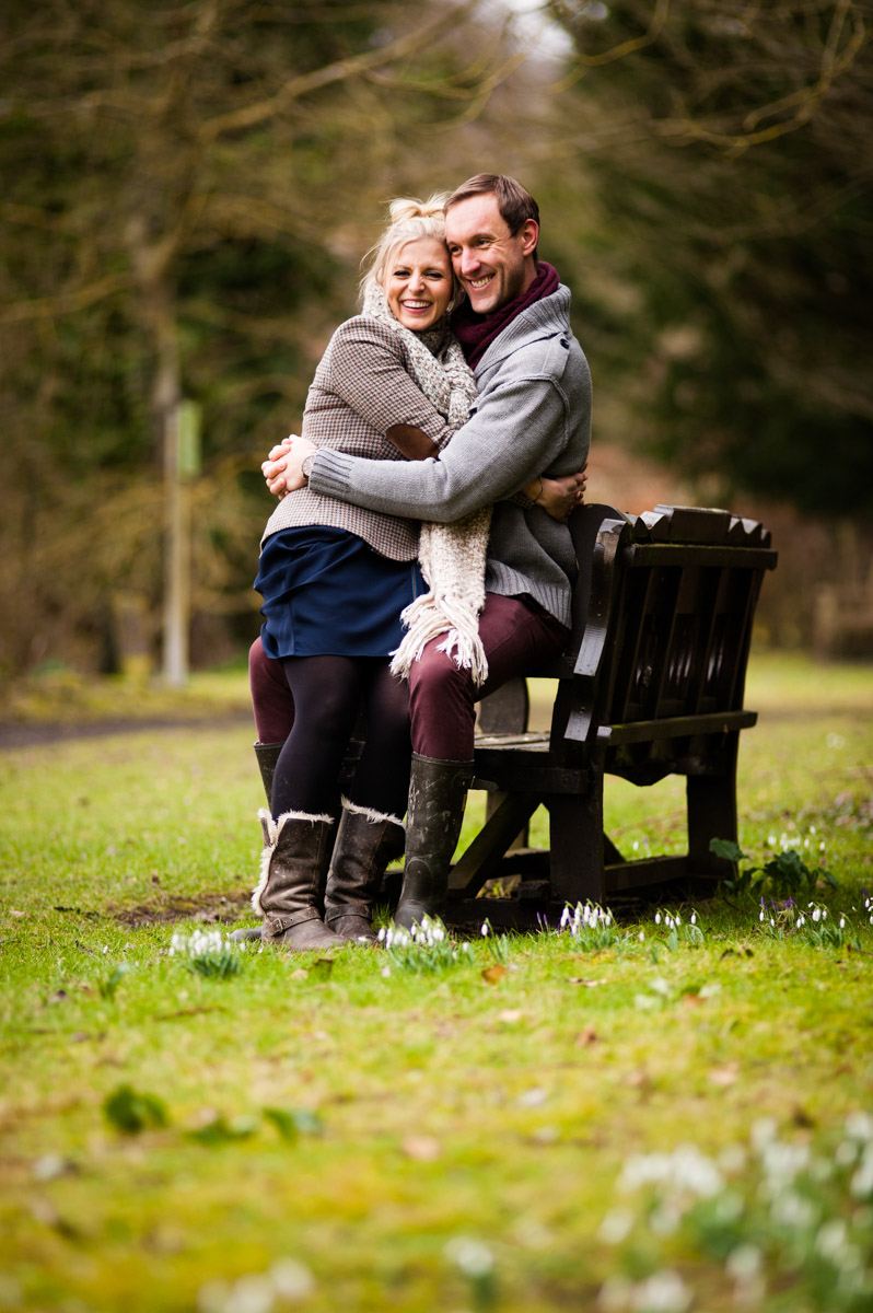 Photograph of Emily and Rob sitting on bench during their pre wedding photoshoot