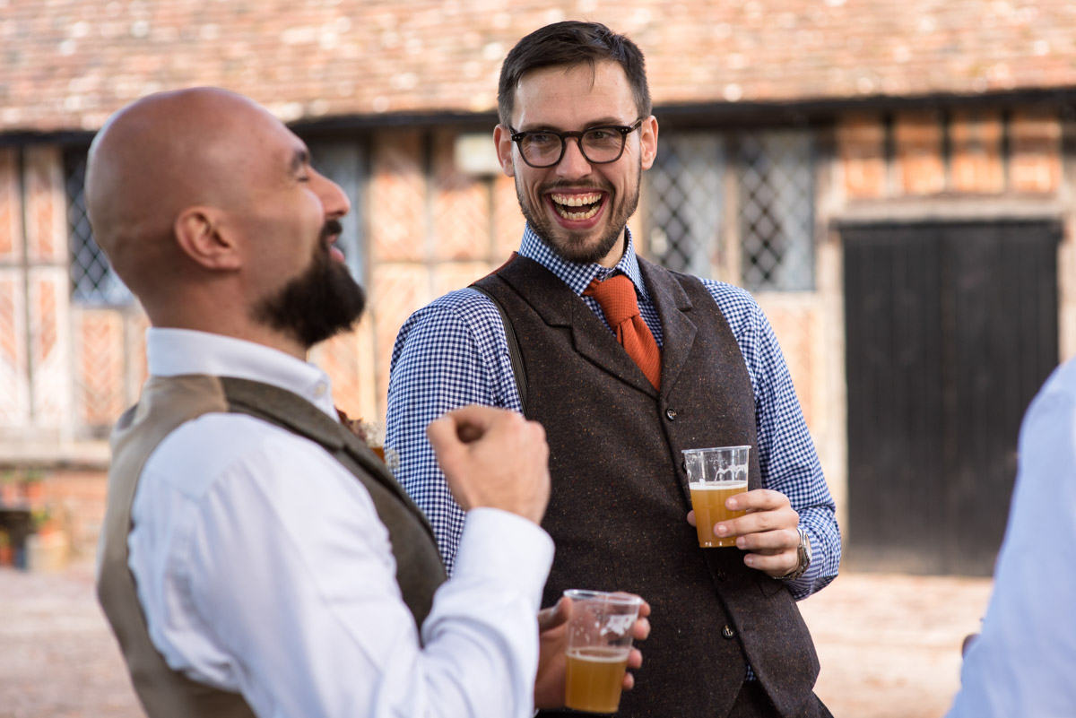 Paul laughs with groomsmen before his Kent wedding at Chilham Village Hall
