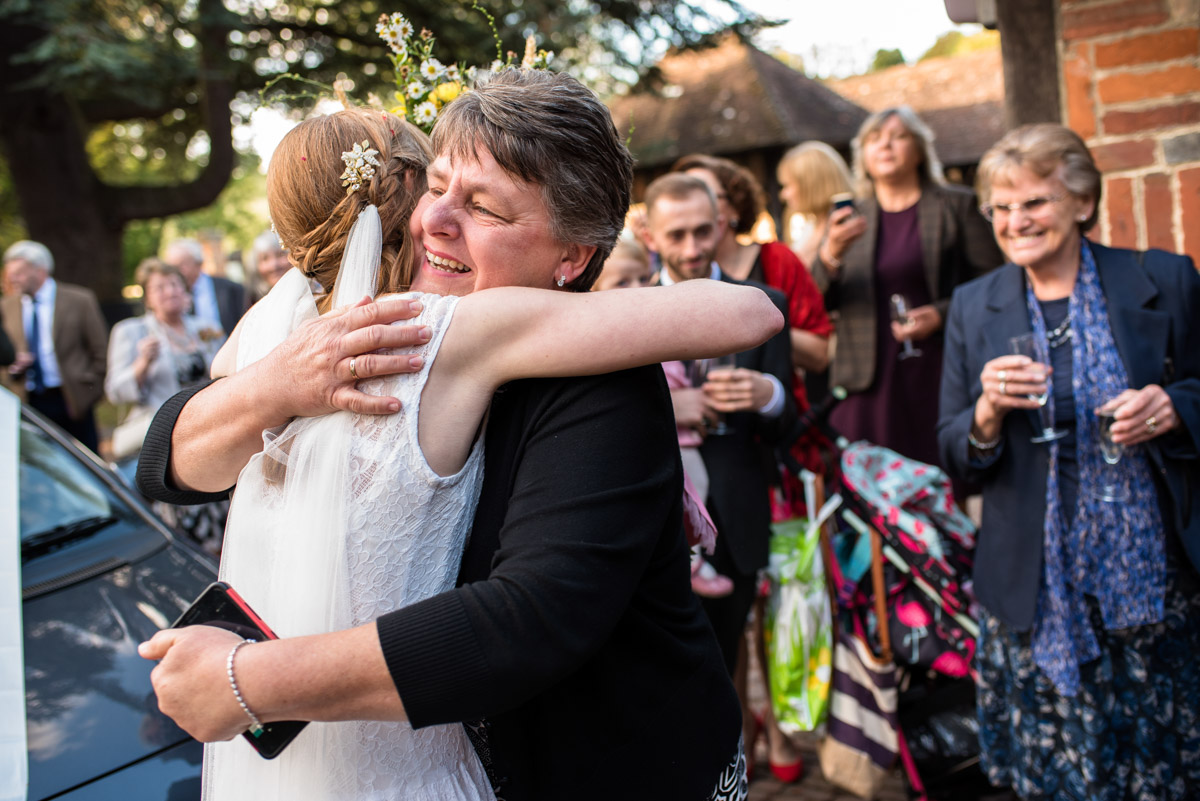 Photograph of Laura being hugged by a wedding guest