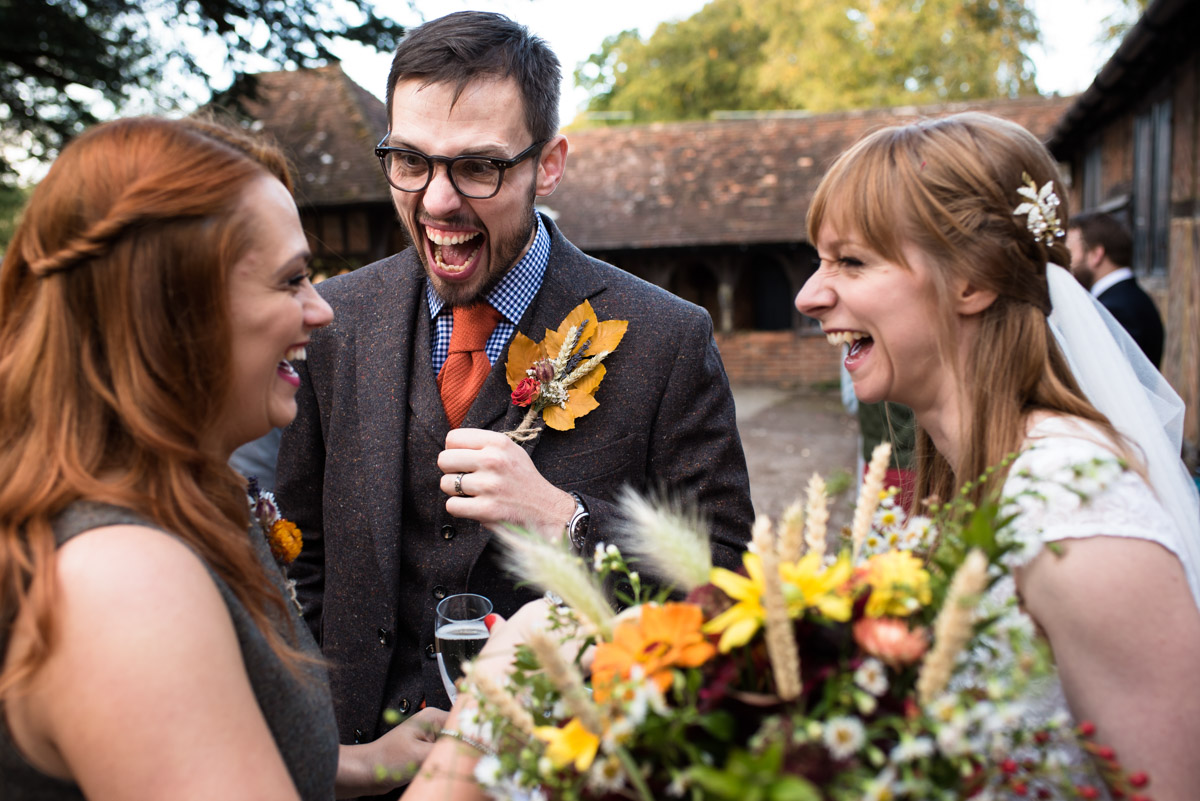 Paul and Laura share a joke with his sister at their Chilahm Village hall wedding