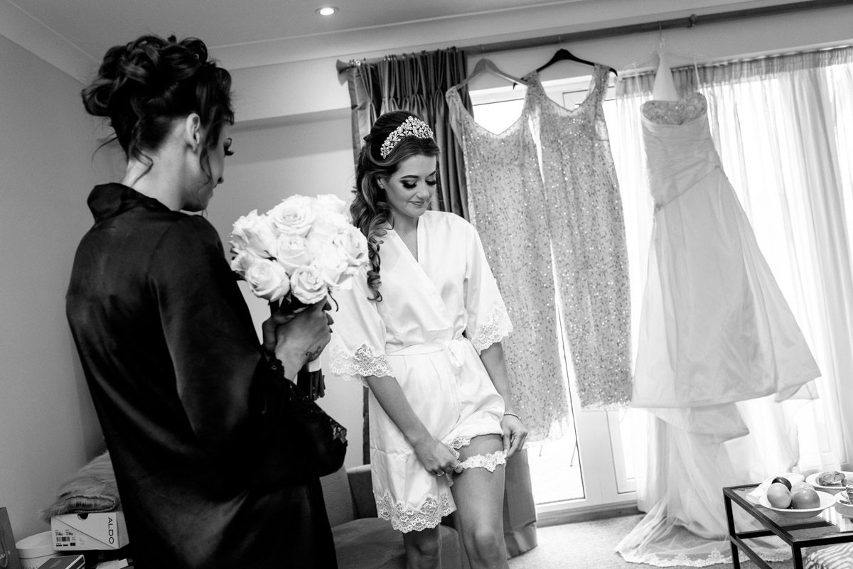 Jade is photographed putting on her garter on her wedding day in Kent
