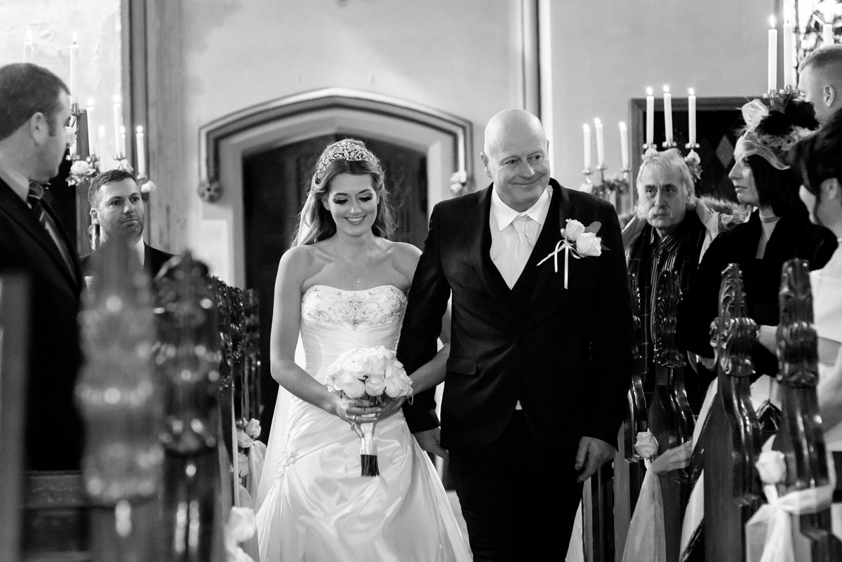 Jade is photographed walking up the aisle with her father at her Kilndown church wedding in Kent
