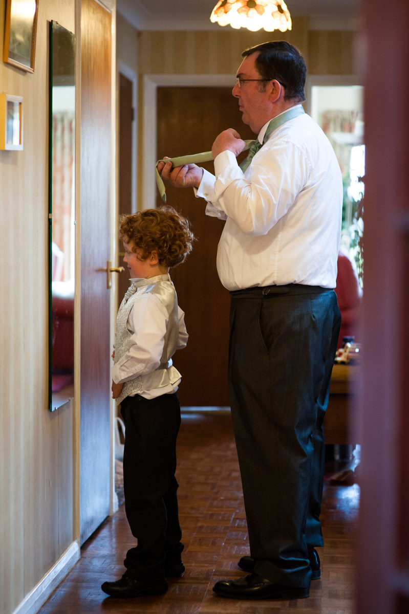 Pageboy and father of the bride getting ready for Charlotte and Chris wedding at Mersham Church in kent