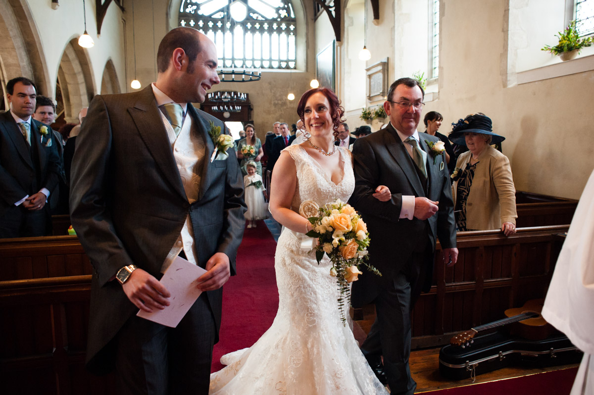 Charlotte is walked up the aisle for her wedding to Chris at Mersham church in Kent