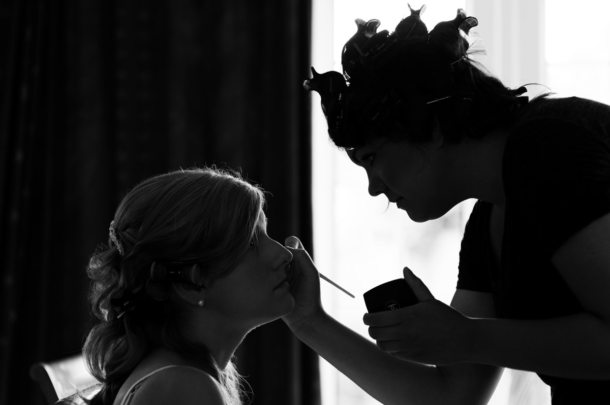 Photograph of Heidi getting her make up applied on her wedding day