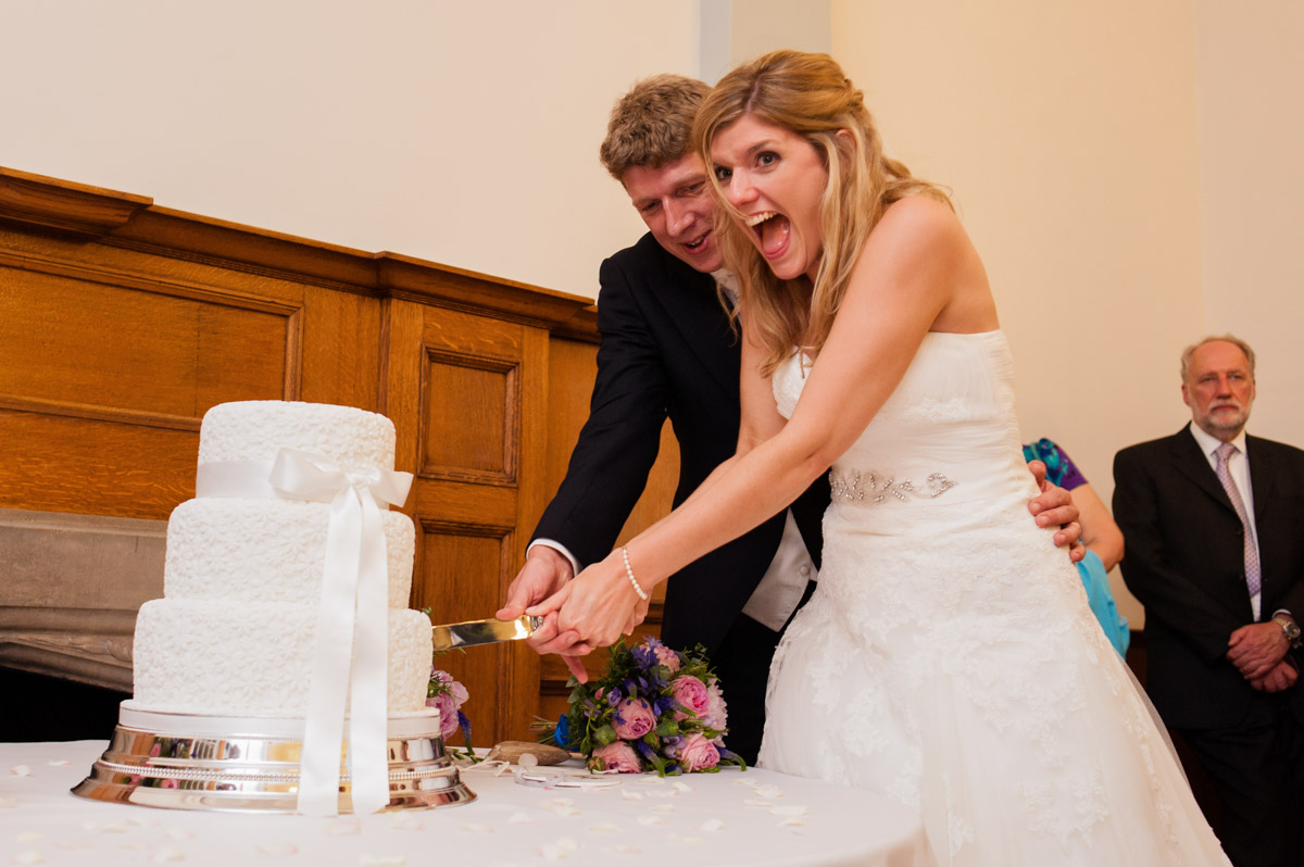 Heidi and James are photographed cutting their wedding cake at The Ward Rooms in Kent