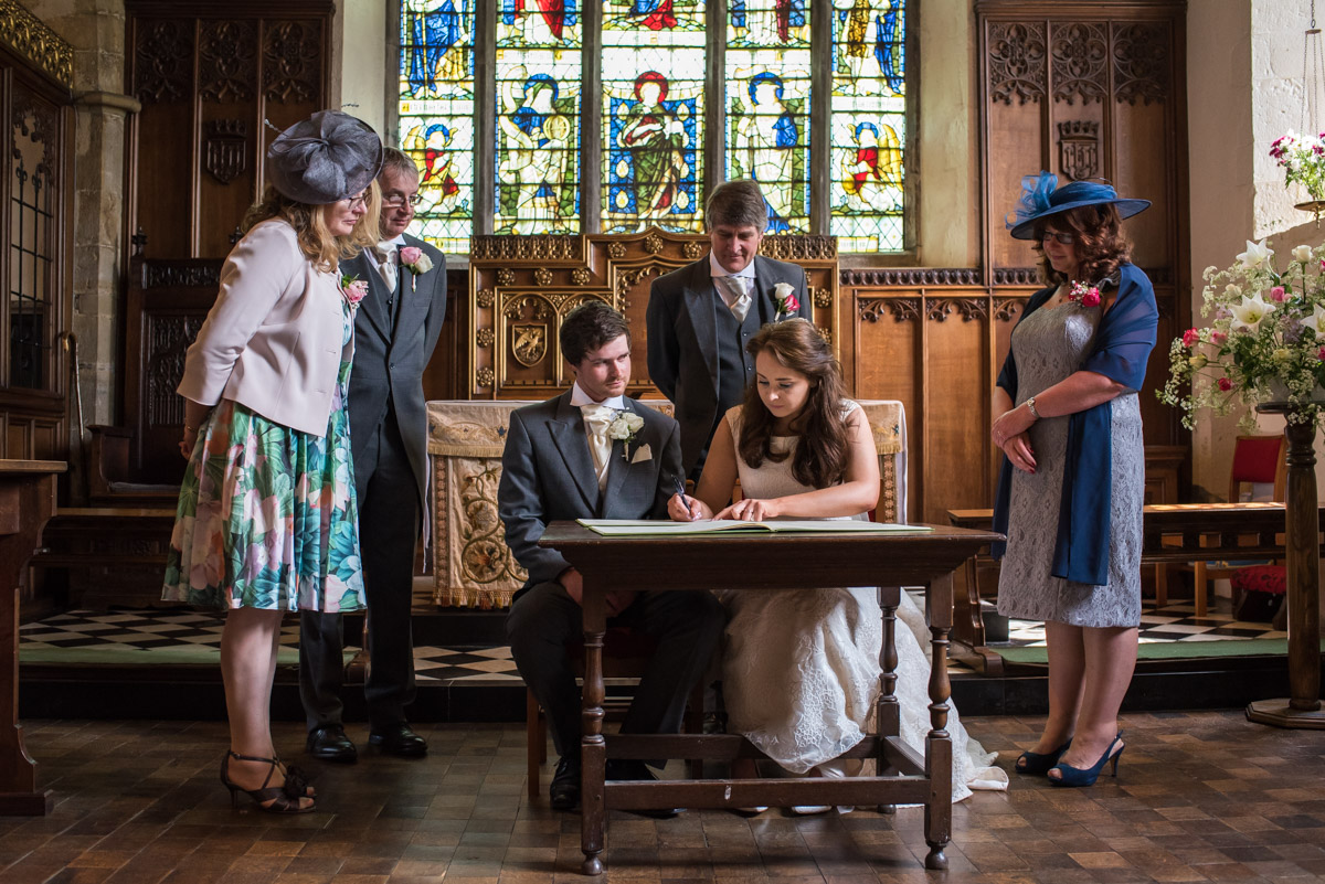 Photograph of sam and Harriet signing wedding register
