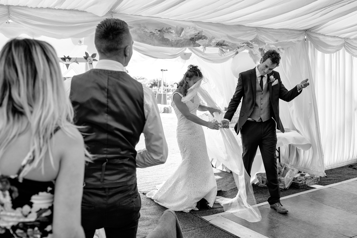 James and Ellie photographed entering the marquee at Kent wedding reception