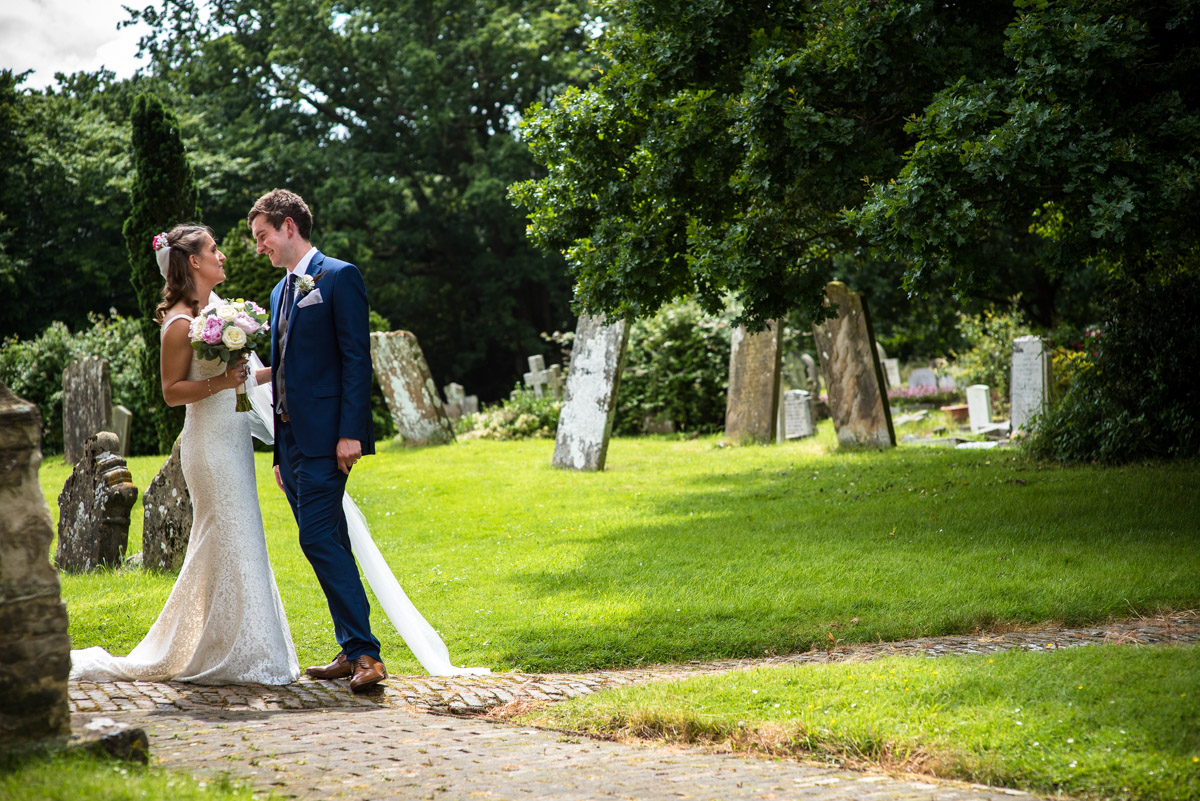 James and Ellie photographed after their Kent wedding ceremony outside church