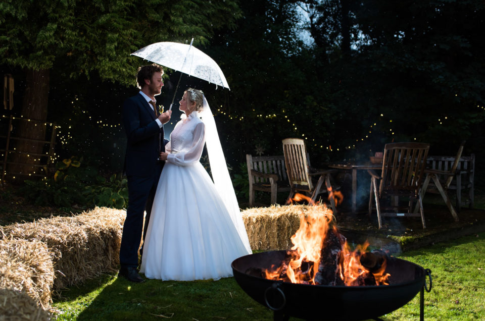 Night time portrait of Jane and Steven outside by the fire pit on their wedding day